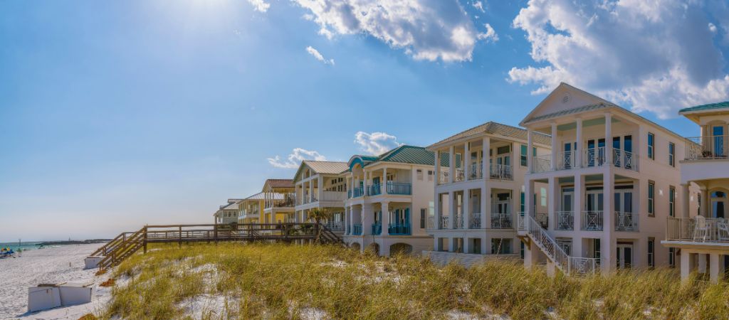 Row of beachfront vacation homes on a sunny day.